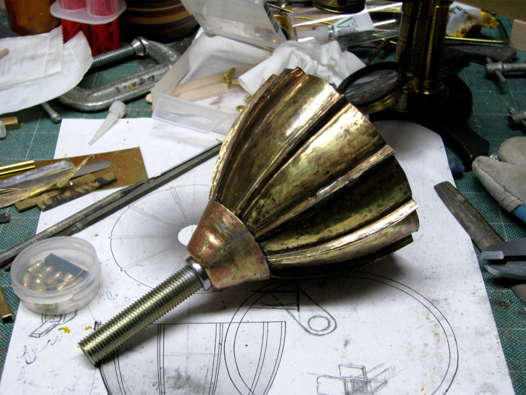 Colour photograph of a brass mouthpiece