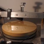 Colour photograph of a wax disc on the wax shaving device