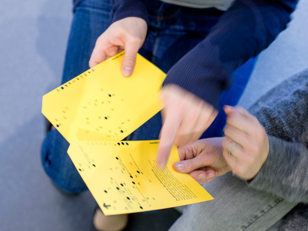 Colour photograph of museum visitors receiving an optical read out card