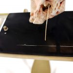 Colour photograph of a 3d printed inner ear attached to a glass etching plate