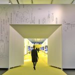 Colour photograph of a visitor entering the doorway of a new exhibition