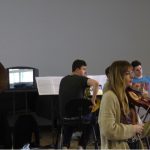 Colour photograph of the horns section of the RCM orchestra rehearsing at the RCM