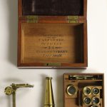 Colour photograph of a small microscope by Philip Carpenter in mahogany box