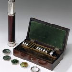 Colour photograph of a kaleidoscope and wooden storage box