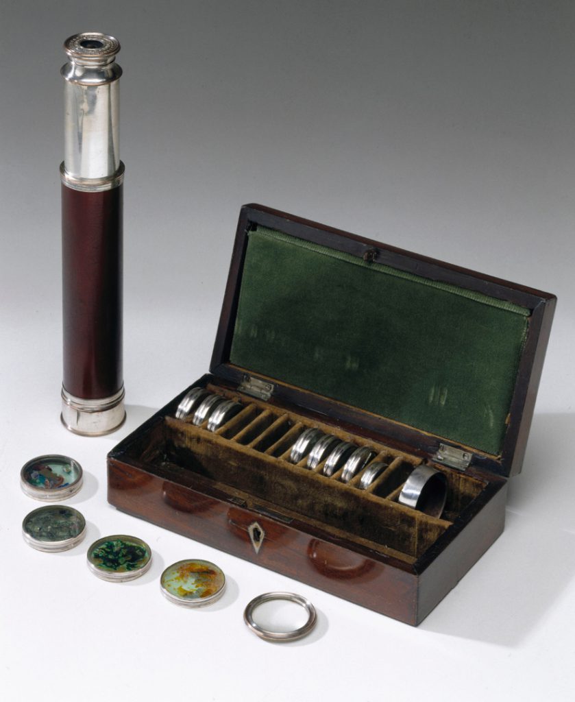Colour photograph of a kaleidoscope and wooden storage box