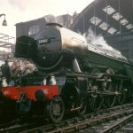 The Flying Scotsman steam train on the tracks at London Kings Cross station