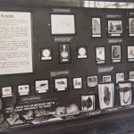 Wellcome Collection exhibition display with objects and images associated with plague