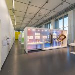 Colour photograph of a bright exhibition space with display objects