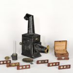 Colour photograph of the Improved Phantasmagoria Lantern by Carpenter and Westley with microscope attachment