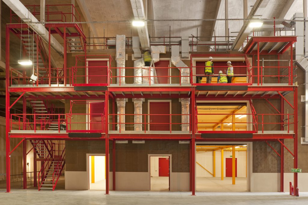 Colour photograph of a steel and hempcrete storage building under construction