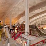 Colour photograph showing construction of storage hangar and installation of the M and E system