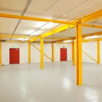 Colour photograph of the ground floor area of the newly completed storage area showing lain floor and steel beams