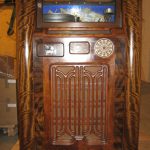 Colour photograph of a wooden multi selector Wurlitzer jukebox from 1936