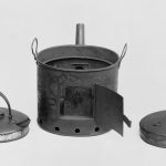 Black and white photograph of a metallic steam kettle