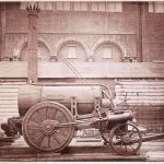 Sepia photograph of the Rocket steam powered rail engine outside the Patent Office Museum