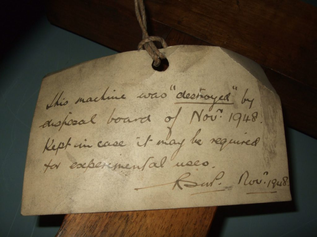 Colour photograph of an object tag informing that the machine was destroyed but kept in case needed for experimental purposes