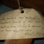 Colour photograph of an object tag informing that the machine was destroyed but kept in case needed for experimental purposes
