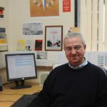 Colour photograph of Jeff Hughes in his office