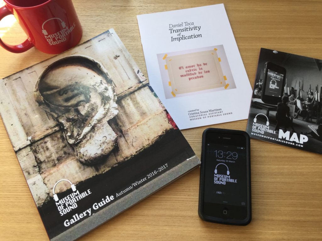 Colour photograph of Museum of Portable Sound visitor materials including a mug