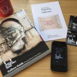 Colour photograph of Museum of Portable Sound visitor materials including a mug