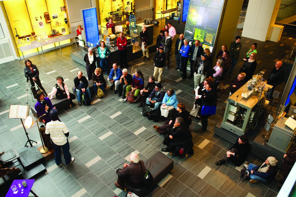 Colour photograph of an actor giving a performance for visitors in the Chemical Heritage Foundation