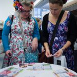 Colour photograph of two participants playing the medical history card game