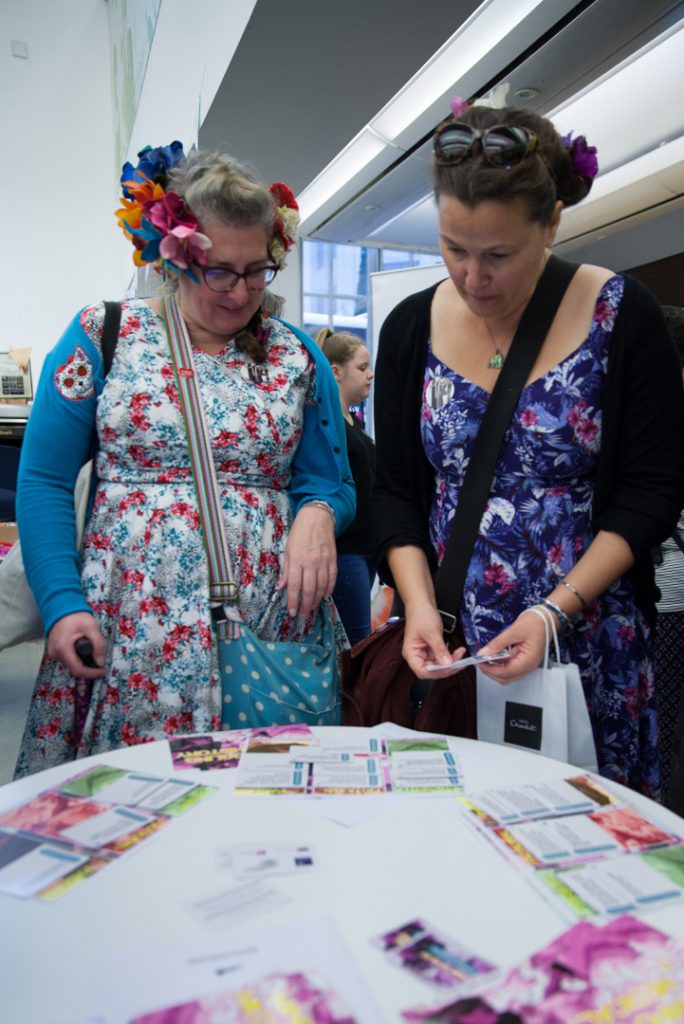Colour photograph of two participants playing the medical history card game