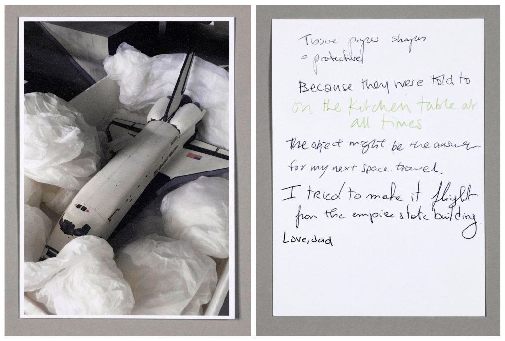 Postcard showing an image of a model spacecraft and hand written answers to questions