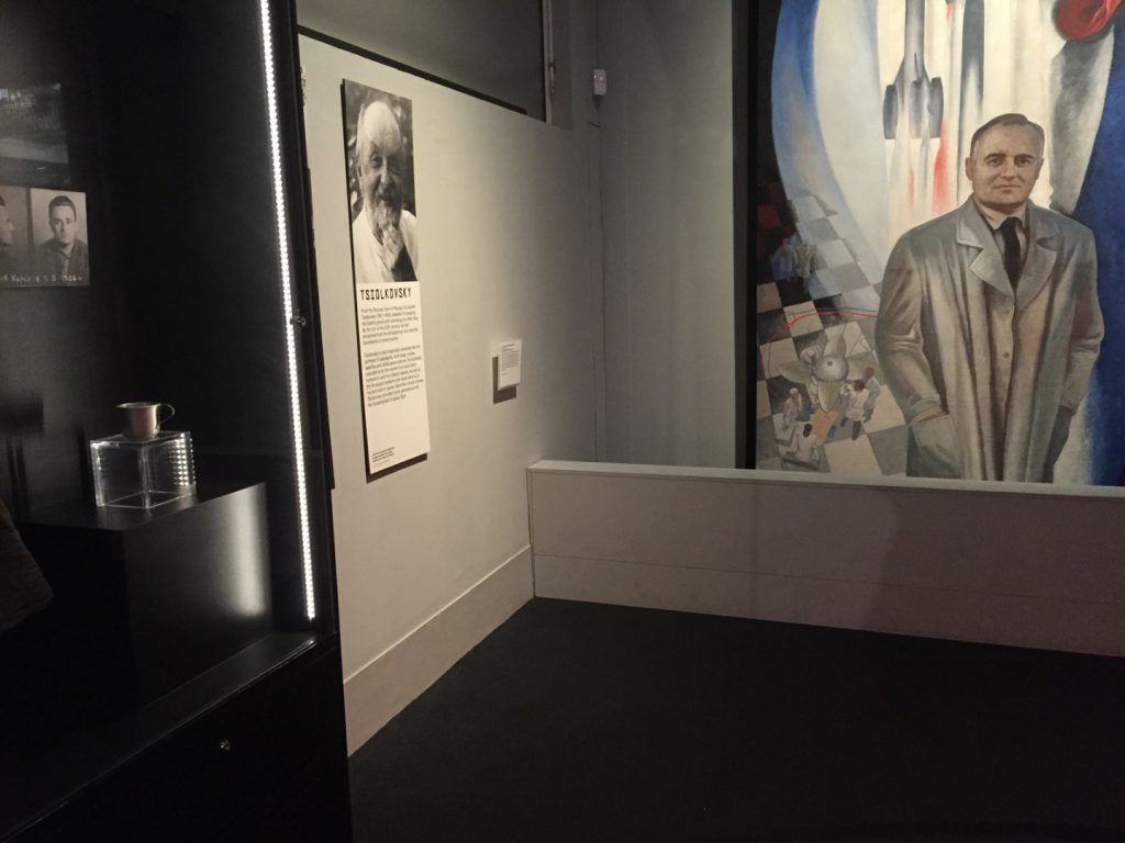 Colour photograph of a section of the Cosmonauts exhibition showing a painting of one of the Soviet designers
