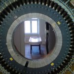 Colour photograph of a medical exhibition showing an MRI scanner and an operating table