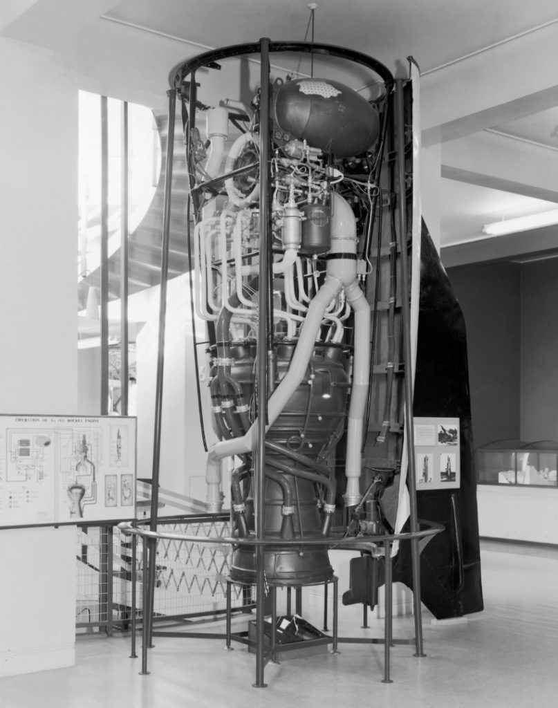 Black and white photograph of a V2 rocket on display as part of an exhibition
