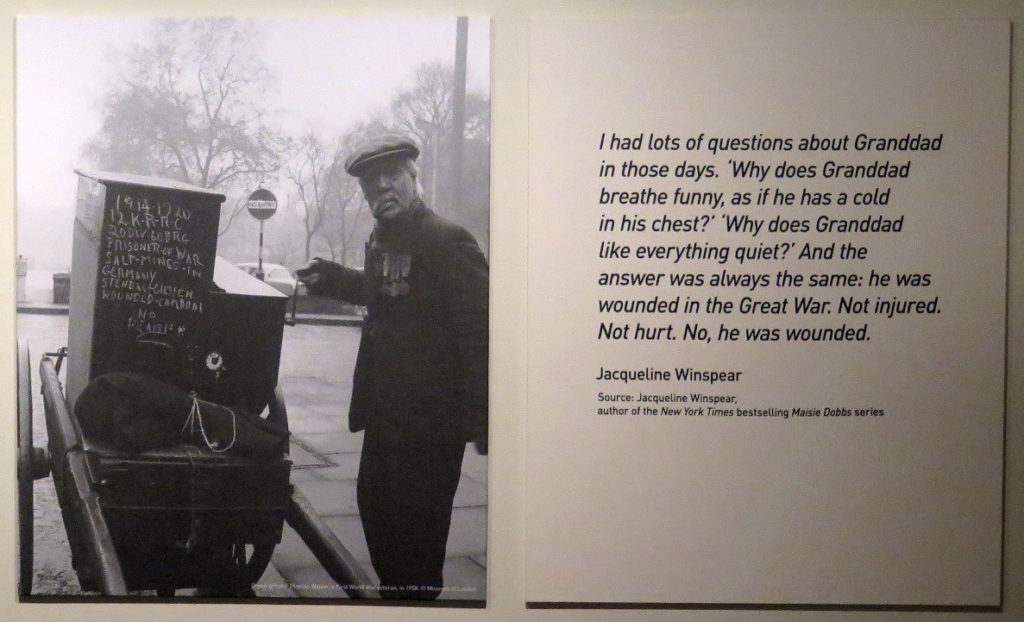Black and white photograph of a street organ grinder on display in the exhibition