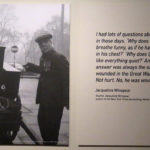 Black and white photograph of a street organ grinder on display in the exhibition