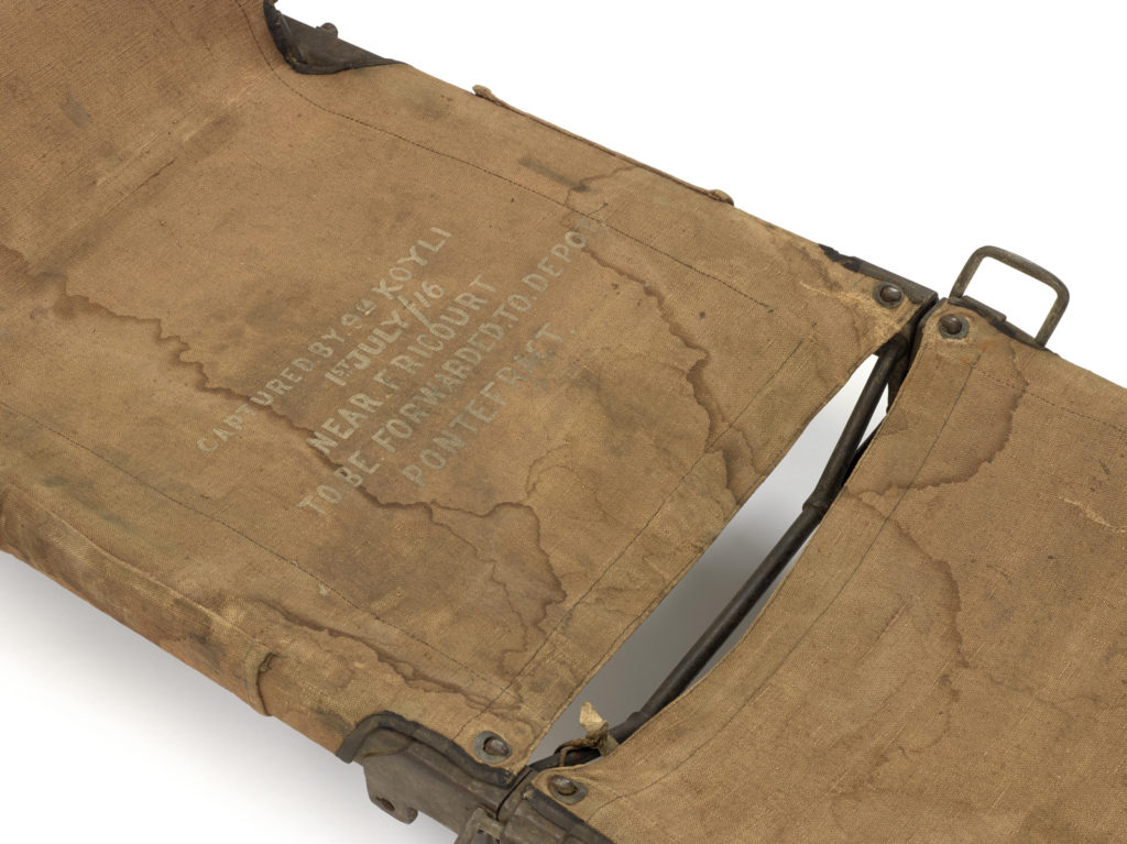 Colour photograph of a stretcher on display in the Wounded exhibition