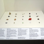 Colour photograph of a case displaying soldiers lucky charms