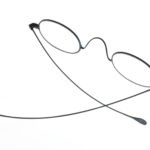 Colour photograph of a thin steel frame pair of spectacles