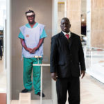 Colour photograph of Samson Lokele with Sîan Daveys on gallery portrait