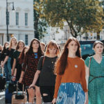 A group of women form a line in silent protest