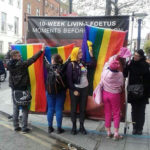 A group of protesters attempt to cover a graphic anti abortion banner
