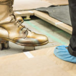 Colour photograph of the foot and floor fastening of the Self Conscious Gene sculpture