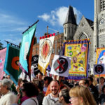 A group of protesters hold colourful banners in support of repealing irish abortion law