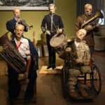 Colour photograph of a sculptured installation of wounded soldiers plaing musical instruments