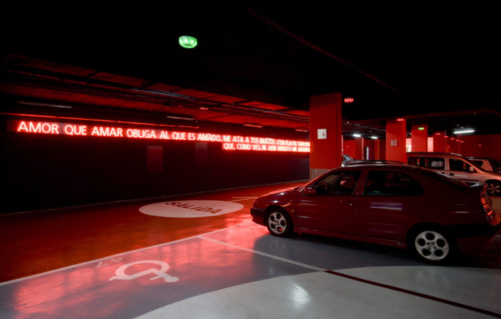Colour photograph of an AIDS memorial using neon lighting in an underground par park