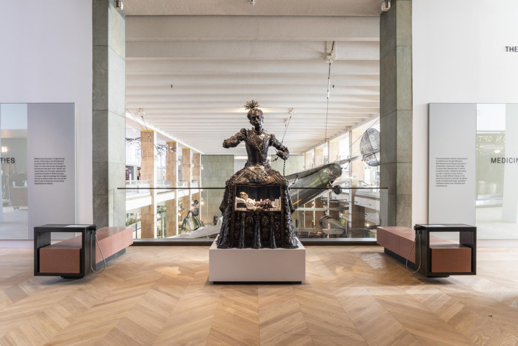 Colour photograph of the Santa Medicina sculpture situated on gallery