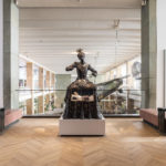 Colour photograph of the Santa Medicina sculpture situated on gallery