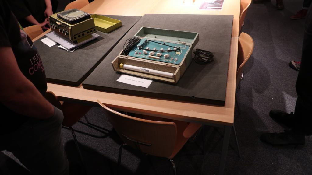 Colour photograph of echo effects units on display for an audience listening group