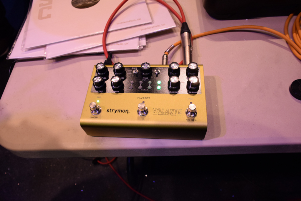 Colour photograph of an echo effects unit on display for an audience listening group