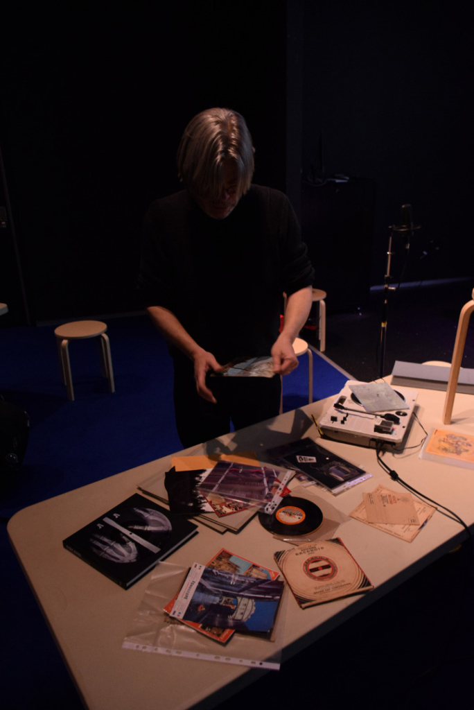 Colour photograph of Aleksander Kolkowski demonstrating a collection of vintage sound postcards