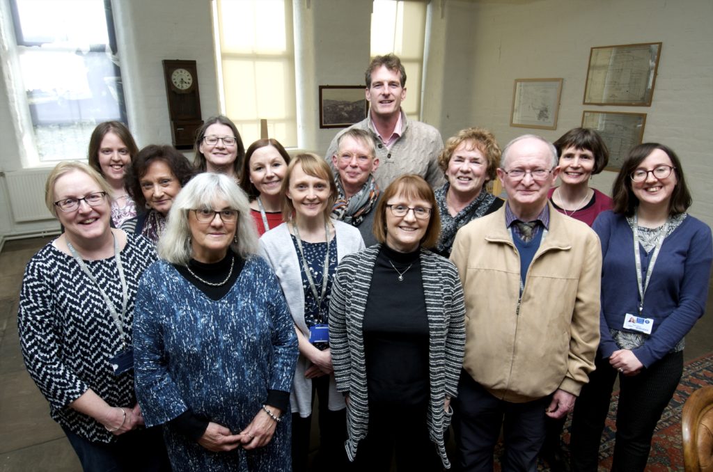 Colour photograph of a group of volunteers working at the Saltaire Collection
