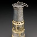 Colour photograph of a late nineteenth century miners safety lamp